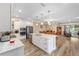 Open concept kitchen with stainless steel appliances, a central island, and seamless flow into the dining and living areas at 9276 Sw 89Th St Rd, Ocala, FL 34481