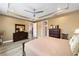 Large main bedroom featuring neutral colors, tray ceilings, and wood flooring at 9276 Sw 89Th St Rd, Ocala, FL 34481