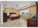 Spacious main bedroom featuring tray ceilings, a ceiling fan, and light wood flooring at 9276 Sw 89Th St Rd, Ocala, FL 34481