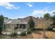 A view of the house from the backyard showing a screened in porch and nicely landscaped yard at 9285 Sw 90Th St, Ocala, FL 34481