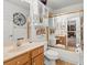 Bright bathroom with oak vanity, large mirror, and a shower/bathtub at 9285 Sw 90Th St, Ocala, FL 34481