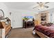 Bedroom with dresser, TV, and view of a hallway to the bathroom at 9285 Sw 90Th St, Ocala, FL 34481