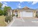 Desirable home featuring two-car garage, decorative shrubbery, walkway to front door, and appealing architecture at 9285 Sw 90Th St, Ocala, FL 34481