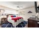 Cozy bedroom featuring a ceiling fan, plush rug, and windows offering natural light at 9691 Sw 95Th Ct # D, Ocala, FL 34481