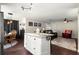 Kitchen island with white cabinets and countertop, adjacent to an open concept living area at 9691 Sw 95Th Ct # D, Ocala, FL 34481