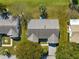 Aerial view of a single-Gathering home with a landscaped yard and paved driveway at 9884 Se 175Th Pl, Summerfield, FL 34491