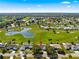 Beautiful aerial view of a home and community, complemented by lush greenery, ponds, and nearby homes at 9884 Se 175Th Pl, Summerfield, FL 34491