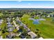 Captivating aerial view of the neighborhood featuring golf course, water feature and lush greenery at 9884 Se 175Th Pl, Summerfield, FL 34491