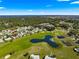 Gorgeous aerial view showcases a community featuring a golf course, water feature, and well-kept landscaping at 9884 Se 175Th Pl, Summerfield, FL 34491