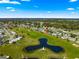 Stunning aerial view of the community with a golf course, water feature, and well-maintained homes at 9884 Se 175Th Pl, Summerfield, FL 34491