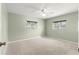 Cozy bedroom with neutral carpet, ceiling fan, and two windows at 9884 Se 175Th Pl, Summerfield, FL 34491