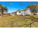 Lawn view of the home with green lawn and mature trees at 9884 Se 175Th Pl, Summerfield, FL 34491