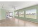 Inviting Gathering room with light green walls and sliding doors to an enclosed porch at 9884 Se 175Th Pl, Summerfield, FL 34491