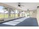 Spacious sunroom overlooking the golf course with a ceiling fan at 9884 Se 175Th Pl, Summerfield, FL 34491