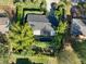 An aerial view of the home showing its dark roof, mature trees, and adjacent properties at 10958 Sw 86Th Ct, Ocala, FL 34481
