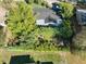 A high-angle aerial view of the home showcasing its dark roof, mature trees, and private backyard at 10958 Sw 86Th Ct, Ocala, FL 34481