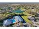 Aerial view of neighborhood featuring golf course, a pond and community amenities at 10958 Sw 86Th Ct, Ocala, FL 34481