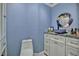 Stylish bathroom featuring a decorative bowl sink, mirror, and white vanity with a gray countertop at 10958 Sw 86Th Ct, Ocala, FL 34481