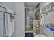 Bathroom with glass-enclosed tiled shower, built-in niches, and stone flooring at 10958 Sw 86Th Ct, Ocala, FL 34481