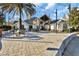 An outdoor patio area features gray pavers and elegant lighting with building in background at 10958 Sw 86Th Ct, Ocala, FL 34481