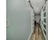 Long hallway with wood-look flooring and white barn doors at 10958 Sw 86Th Ct, Ocala, FL 34481
