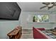 A stylish living room with hardwood floors, large windows, neutral walls, and modern decor at 10958 Sw 86Th Ct, Ocala, FL 34481