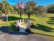 Memorial park with flag, monuments, benches, and manicured landscaping at 10958 Sw 86Th Ct, Ocala, FL 34481