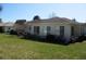 Back exterior of the house showing windows, well-kept lawn, and tidy landscaping at 11353 Sw 138Th Ln, Dunnellon, FL 34432
