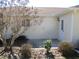 View of a small patio with a door to the house and some bushes in the landscaping at 11353 Sw 138Th Ln, Dunnellon, FL 34432