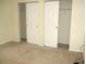 Bedroom featuring neutral carpet, fresh paint, and double closets at 11353 Sw 138Th Ln, Dunnellon, FL 34432