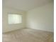 Bedroom featuring a large window with blinds and neutral carpeting for a cozy feel at 11353 Sw 138Th Ln, Dunnellon, FL 34432