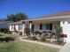 Charming single-story home featuring red shutters, columns, and well-maintained landscaping at 11353 Sw 138Th Ln, Dunnellon, FL 34432