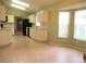 Open concept kitchen and dining area with abundant natural light from surrounding windows at 11353 Sw 138Th Ln, Dunnellon, FL 34432
