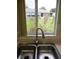 View from kitchen sink overlooking the backyard and a neighboring house at 11353 Sw 138Th Ln, Dunnellon, FL 34432
