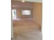 View of spacious carpeted living room with large window letting in natural light at 11353 Sw 138Th Ln, Dunnellon, FL 34432