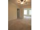 Living area featuring a ceiling fan, offering a view into another room at 11353 Sw 138Th Ln, Dunnellon, FL 34432