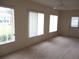 Bright living room filled with lots of natural light, featuring a sliding glass door and multiple windows at 11353 Sw 138Th Ln, Dunnellon, FL 34432