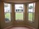 Bay window view with backyard and landscaping at 11353 Sw 138Th Ln, Dunnellon, FL 34432