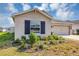 Lovely home featuring a manicured lawn, dark window shutters, and an attached two-car garage at 1157 Saguaro St, Haines City, FL 33844