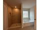 Inviting bathroom showcasing a shower and soaking tub with modern fixtures and great natural light at 120 Dogwood Drive Cir, Ocala, FL 34472