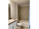 Bathroom featuring vanity, toilet and a tub-shower combination with tiled surround at 120 Dogwood Drive Cir, Ocala, FL 34472