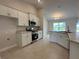 Modern kitchen features white cabinets, granite countertops, stainless steel appliances and tile flooring at 120 Dogwood Drive Cir, Ocala, FL 34472