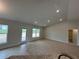 Bright living room features recessed lighting and access to the backyard through glass door at 120 Dogwood Drive Cir, Ocala, FL 34472