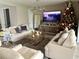 Cozy living room with comfortable seating, a decorative Christmas tree, and a warm, inviting ambiance at 1229 Hillcrest View Loop, Apopka, FL 32703