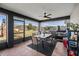 The screened in patio features a dining table, ceiling fan and a nice view of the backyard at 13161 Sw 2Nd Ct, Ocala, FL 34473