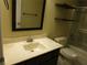 This bathroom has a single vanity sink, a toilet, and a shower/tub with shelves for storage at 14180 Se 53Rd Ave, Summerfield, FL 34491