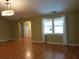 Bright living room with hardwood floors, large window, and neutral color palette at 14180 Se 53Rd Ave, Summerfield, FL 34491