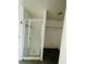 Bathroom with tiled shower and view into an adjacent closet or dressing room at 15040 Sw 29Th St, Ocala, FL 34481