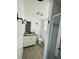 Bathroom features white cabinets with granite countertop, shower, toilet, and gray wood-look flooring at 15040 Sw 29Th St, Ocala, FL 34481