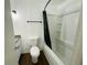 Bathroom with white toilet and granite countertop next to tub with black shower curtain rod at 15040 Sw 29Th St, Ocala, FL 34481